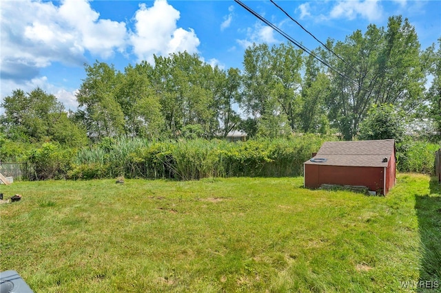 85 Pacific Ave, Lackawanna, NY 14218 - view of green lawn featuring a storage unit and view of wooded area
