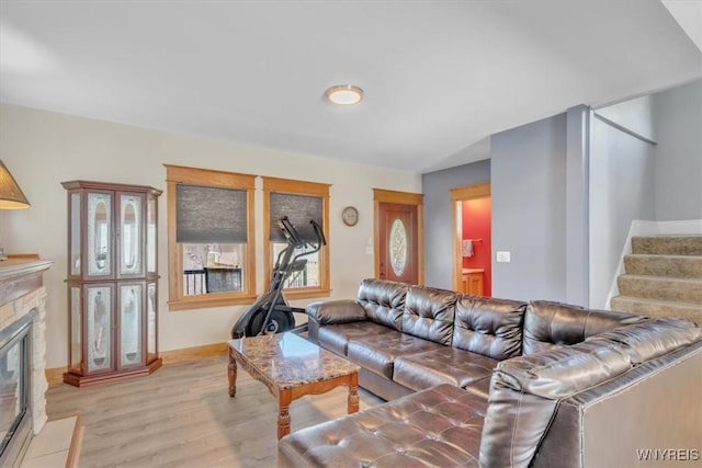 67 Amber St, Buffalo, NY 14220 - living room featuring light wood finished floors, stairway, and a fireplace