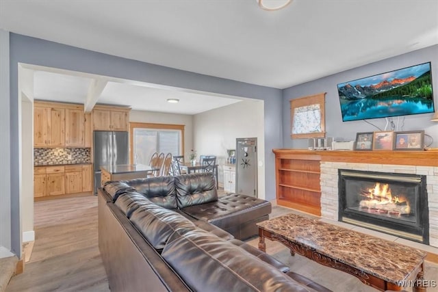 67 Amber St, Buffalo, NY 14220 - living area with a fireplace, light wood-type flooring, and beamed ceiling