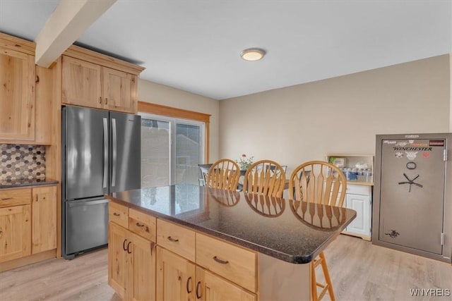 67 Amber St, Buffalo, NY 14220 - kitchen with light brown cabinets, freestanding refrigerator, light wood finished floors, and a center island