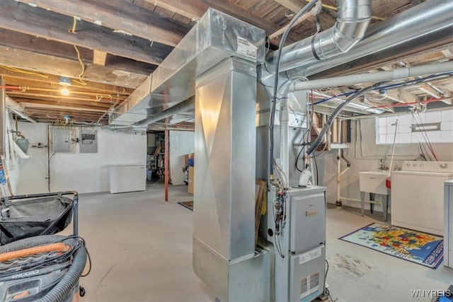 67 Amber St, Buffalo, NY 14220 - below grade area with washer and clothes dryer, electric panel, and heating unit