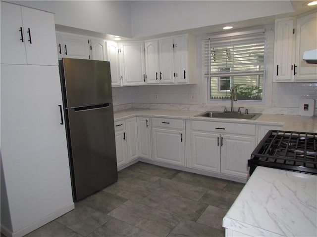 176 Selye Ter, Rochester, NY 14613 - kitchen with freestanding refrigerator, decorative backsplash, gas stove, white cabinets, and recessed lighting