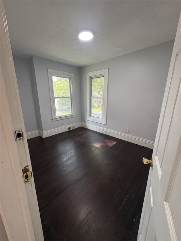 176 Selye Ter, Rochester, NY 14613 - unfurnished room with baseboards and dark wood-style floors