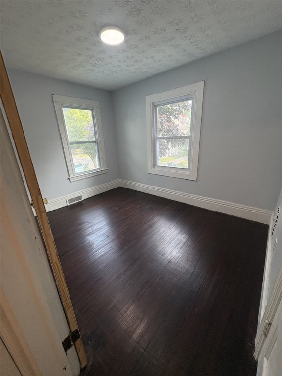 176 Selye Ter, Rochester, NY 14613 - empty room featuring dark wood-style flooring and a textured ceiling