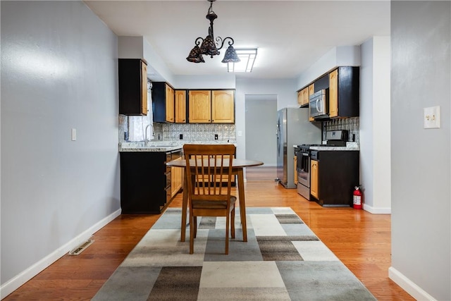 15 Dogwood Ln, Erwin, NY 14870 - kitchen featuring stainless steel appliances, backsplash, and light countertops