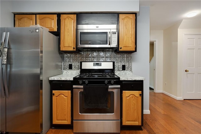 15 Dogwood Ln, Erwin, NY 14870 - kitchen featuring stainless steel appliances, wood finished floors, and decorative backsplash