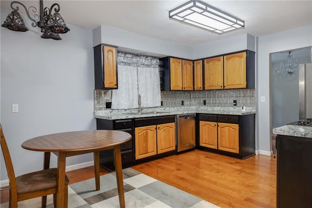 15 Dogwood Ln, Erwin, NY 14870 - kitchen with light wood-style floors, decorative backsplash, appliances with stainless steel finishes, and brown cabinetry