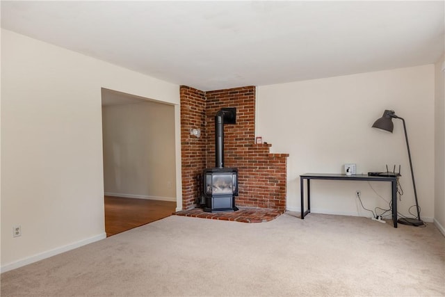 15 Dogwood Ln, Erwin, NY 14870 - unfurnished living room featuring carpet floors and a wood stove