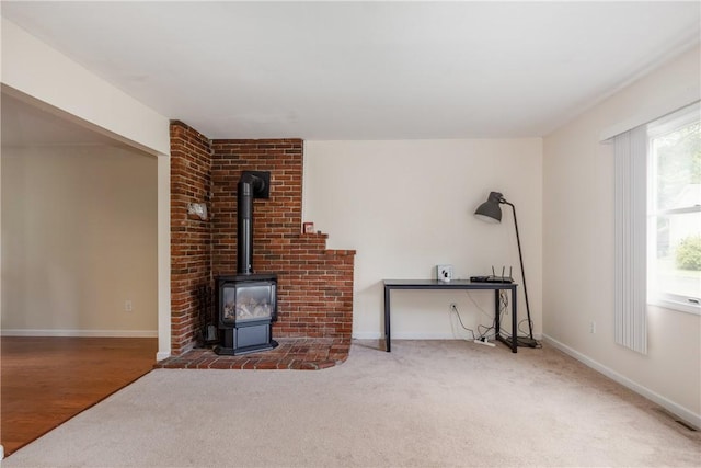 15 Dogwood Ln, Erwin, NY 14870 - unfurnished living room with a wood stove and carpet flooring