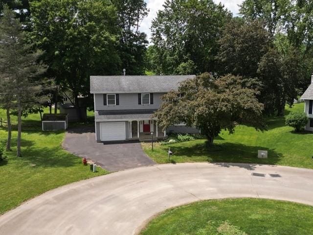 15 Dogwood Ln, Erwin, NY 14870 - view of front of property featuring curved driveway, a front yard, and a garage