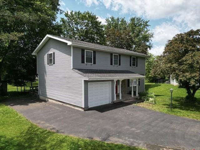 15 Dogwood Ln, Erwin, NY 14870 - traditional-style house with a front lawn, asphalt driveway, a porch, and a garage