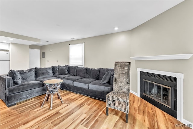 306 Sundown Unit 3C, Amherst, NY 14221 - living area featuring wood finished floors, a glass covered fireplace, and recessed lighting