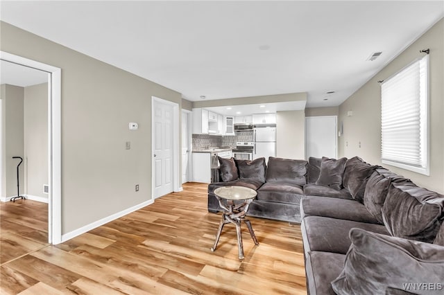 306 Sundown Unit 3C, Amherst, NY 14221 - living area featuring light wood finished floors and baseboards