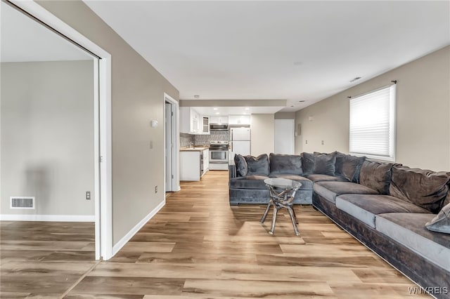 306 Sundown Unit 3C, Amherst, NY 14221 - living area with light wood finished floors and recessed lighting
