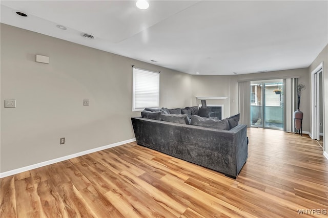 306 Sundown Unit 3C, Amherst, NY 14221 - living area with light wood-type flooring, a fireplace, and recessed lighting