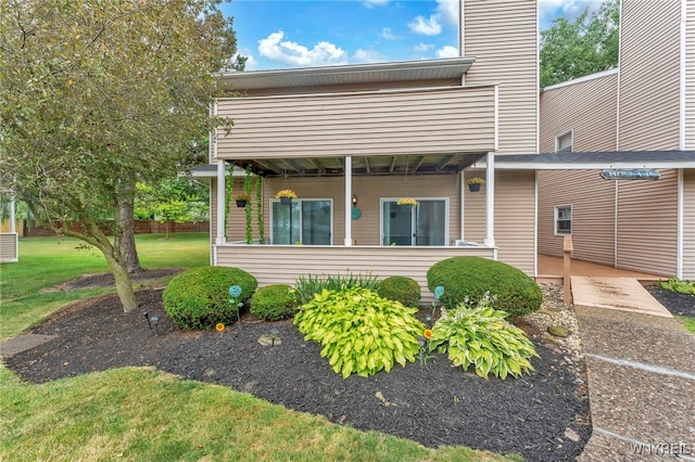 306 Sundown Unit 3C, Amherst, NY 14221 - rear view of house featuring a yard