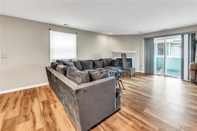 306 Sundown Unit 3C, Amherst, NY 14221 - living room with light wood-style flooring, recessed lighting, and a fireplace with raised hearth