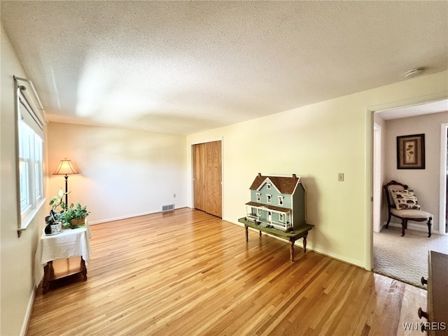 73 Eaglebrook Dr, Orchard Park, NY 14224 - sitting room with wood finished floors and a textured ceiling