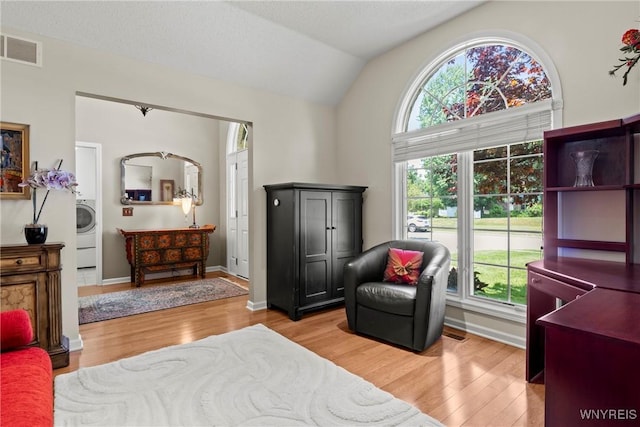 6 Fair Woods Dr, Amherst, NY 14221 - bedroom featuring light wood-type flooring, vaulted ceiling, and washer / clothes dryer