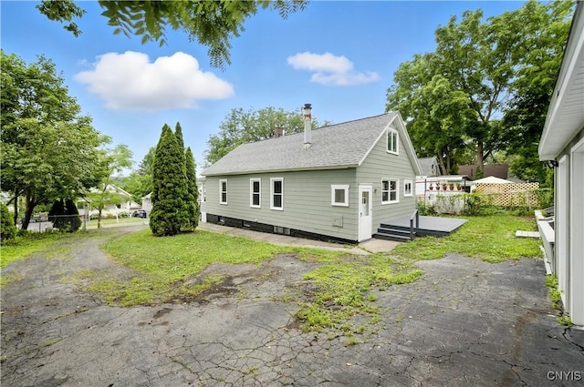 215 Vann St, Syracuse, NY 13206 - view of property exterior with a chimney, a deck, and roof with shingles
