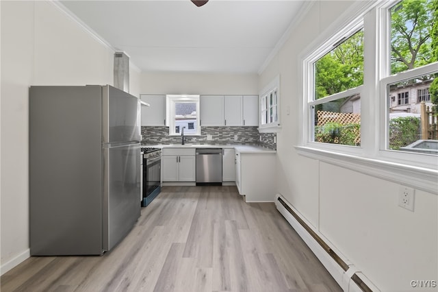 215 Vann St, Syracuse, NY 13206 - kitchen featuring appliances with stainless steel finishes, baseboard heating, light wood-style floors, white cabinets, and light countertops
