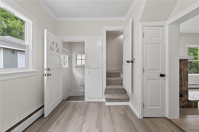 215 Vann St, Syracuse, NY 13206 - foyer entrance with a baseboard heating unit, light wood-style floors, ornamental molding, and a baseboard radiator
