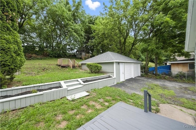 215 Vann St, Syracuse, NY 13206 - view of yard with an outdoor structure, a deck, a garage, and view of wooded area