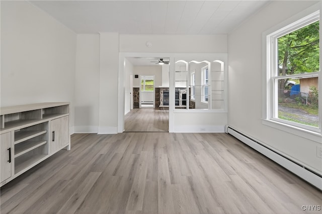 215 Vann St, Syracuse, NY 13206 - unfurnished living room with a fireplace, a ceiling fan, light wood-type flooring, a baseboard radiator, and baseboard heating