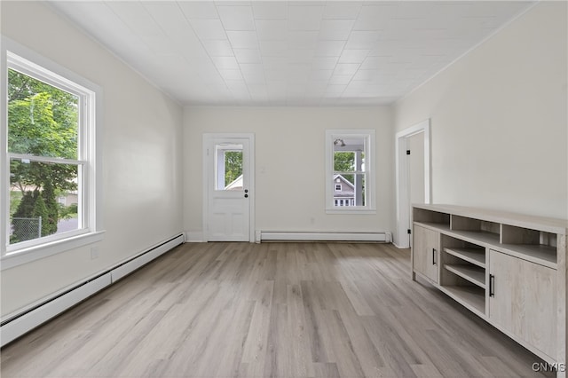 215 Vann St, Syracuse, NY 13206 - unfurnished living room with baseboard heating, light wood-type flooring, and a baseboard radiator