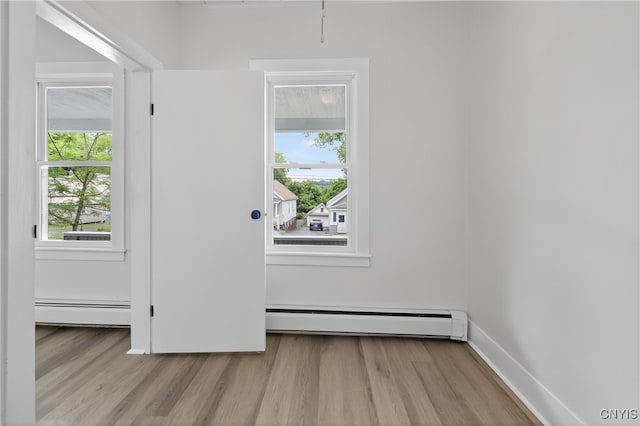 215 Vann St, Syracuse, NY 13206 - doorway with healthy amount of natural light, a baseboard radiator, and wood finished floors