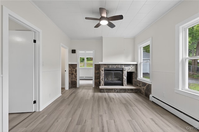 215 Vann St, Syracuse, NY 13206 - unfurnished living room with a baseboard heating unit, wood finished floors, ornamental molding, a ceiling fan, and healthy amount of natural light