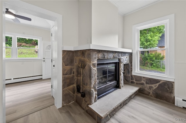215 Vann St, Syracuse, NY 13206 - detailed view of crown molding, wood finished floors, a baseboard heating unit, a fireplace, and ceiling fan