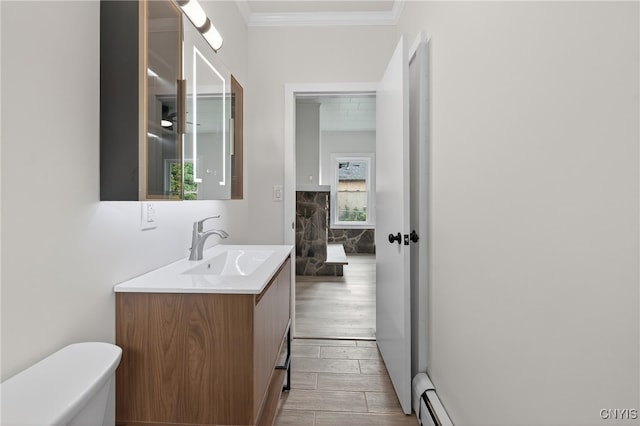215 Vann St, Syracuse, NY 13206 - bathroom with vanity, a baseboard heating unit, ornamental molding, and wood finished floors