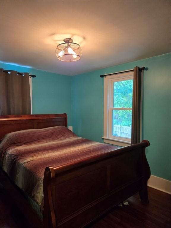 262 E 3rd St, Corning City, NY 14830 - bedroom featuring dark wood-style flooring and baseboards