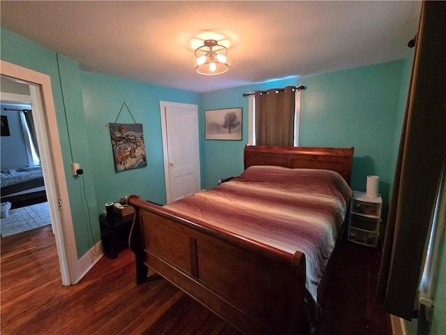 262 E 3rd St, Corning City, NY 14830 - bedroom with dark wood-style flooring and baseboards