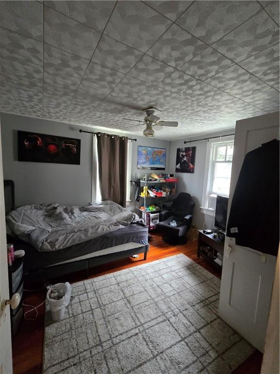 262 E 3rd St, Corning City, NY 14830 - bedroom with wood finished floors and ceiling fan