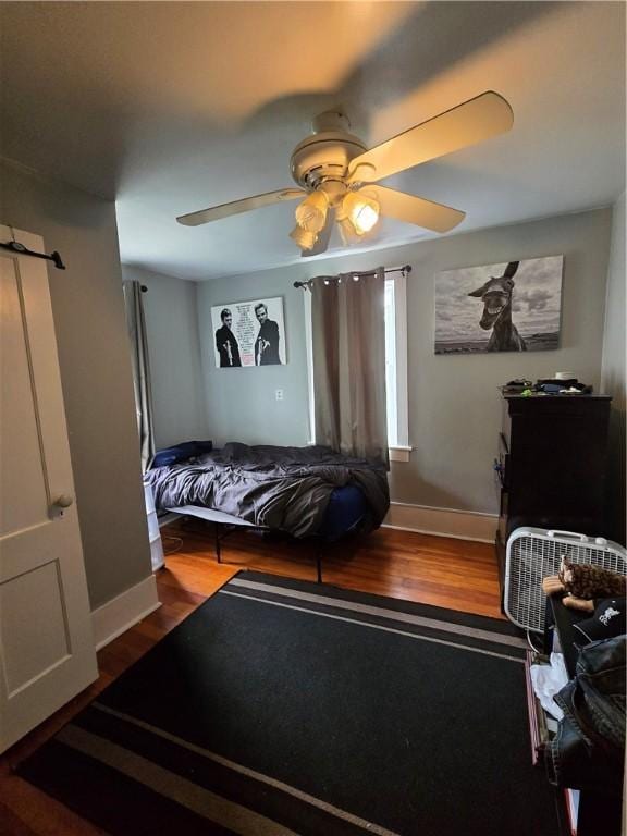 262 E 3rd St, Corning City, NY 14830 - bedroom with wood finished floors and a ceiling fan