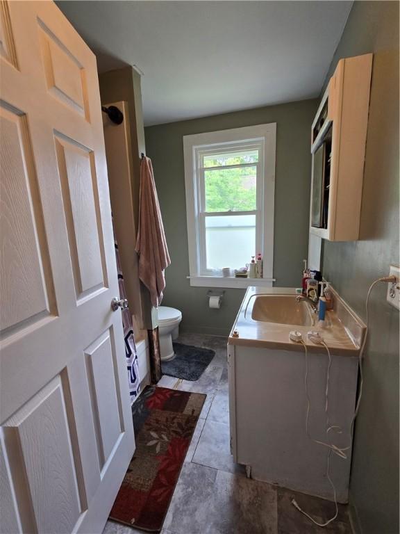262 E 3rd St, Corning City, NY 14830 - bathroom featuring toilet and vanity
