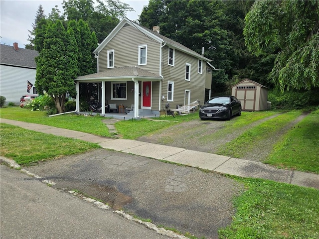 262 E 3rd St, Corning City, NY 14830 - view of front of home with driveway, a shed, covered porch, and a front lawn