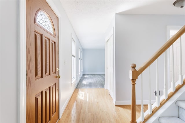 20 Parr Cir, Irondequoit, NY 14617 - foyer entrance with healthy amount of natural light, light wood-style flooring, and stairs