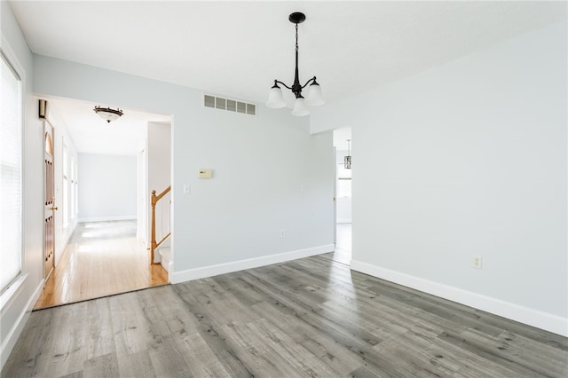 20 Parr Cir, Irondequoit, NY 14617 - empty room with a chandelier, wood finished floors, and stairs