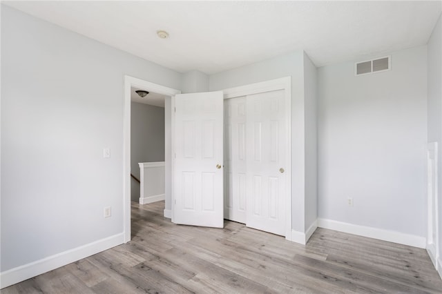 20 Parr Cir, Irondequoit, NY 14617 - unfurnished bedroom featuring wood finished floors and a closet
