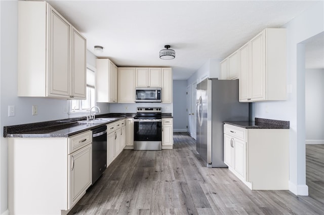 20 Parr Cir, Irondequoit, NY 14617 - kitchen featuring appliances with stainless steel finishes, light wood-type flooring, and dark countertops