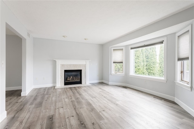 20 Parr Cir, Irondequoit, NY 14617 - unfurnished living room with wood finished floors and a fireplace with flush hearth