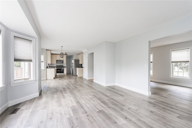 20 Parr Cir, Irondequoit, NY 14617 - unfurnished living room featuring light wood-style floors and healthy amount of natural light
