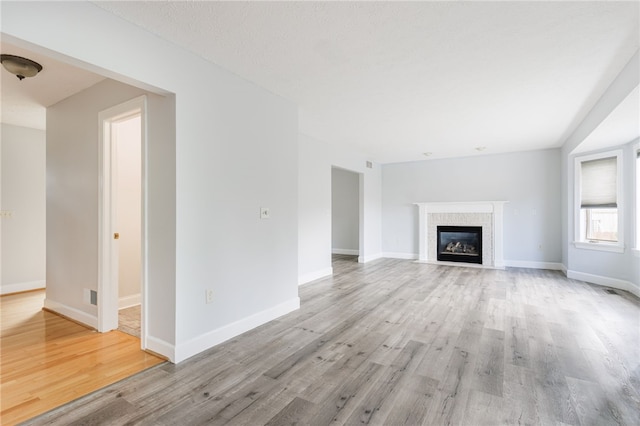 20 Parr Cir, Irondequoit, NY 14617 - unfurnished living room with light wood finished floors and a fireplace with flush hearth