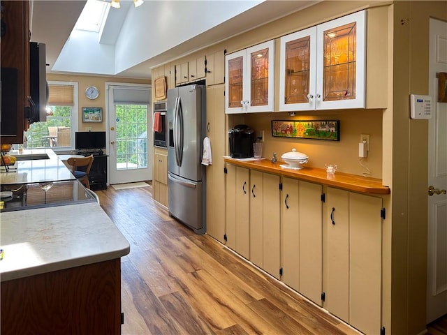 3265 Reading Rd, Reading, NY 14891 - kitchen with a skylight, light wood-style floors, stainless steel appliances, light countertops, and glass insert cabinets
