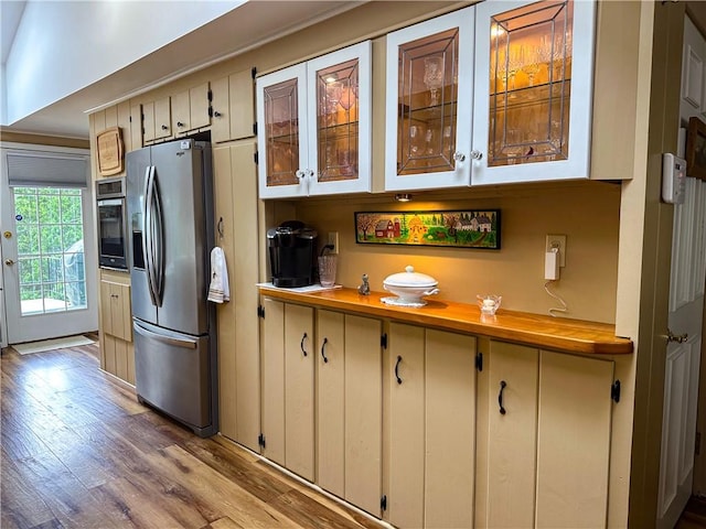 3265 Reading Rd, Reading, NY 14891 - kitchen with stainless steel appliances, light wood-type flooring, glass insert cabinets, and light countertops