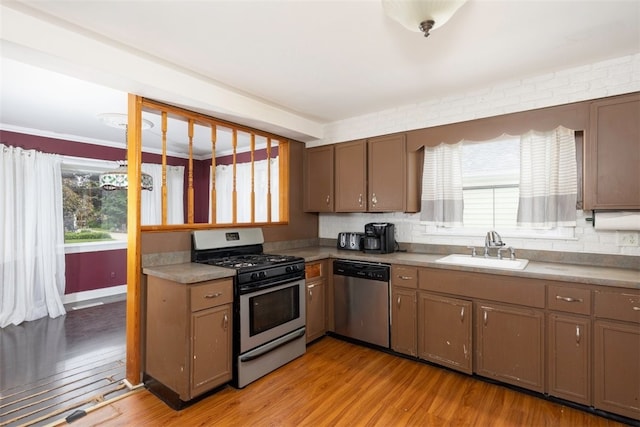 269 Michael Ave, Cheektowaga, NY 14212 - kitchen with stainless steel appliances, light wood-style floors, and backsplash