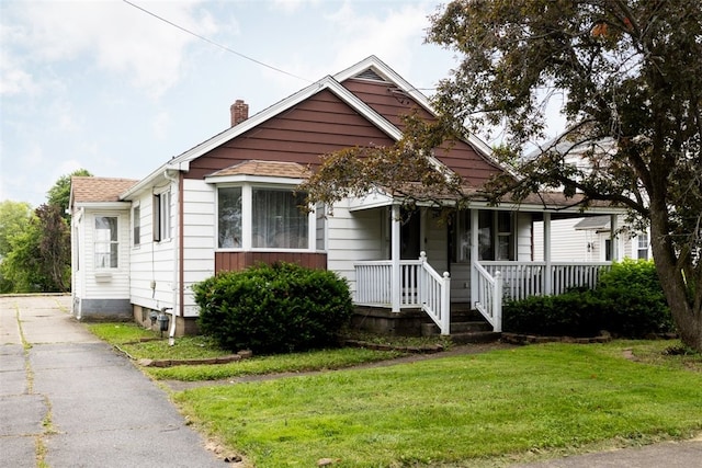 269 Michael Ave, Cheektowaga, NY 14212 - bungalow-style house with covered porch, a chimney, a front lawn, and roof with shingles